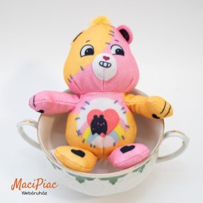   Mc donalds plüss figura, maci 2025 rózsaszín-sárga) Gondos Bocsok (Care Bears) karakterek patchwork, azaz foltvarrás stílusú Halloween Tenderheart Bear  Csupaszív bocsiadás 